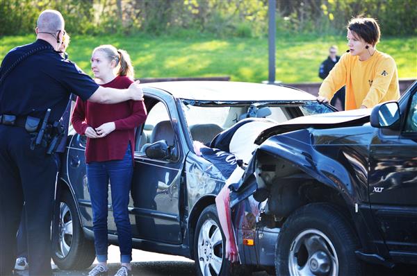 Police comfort an accident victim during Henderson's Mock Crash 